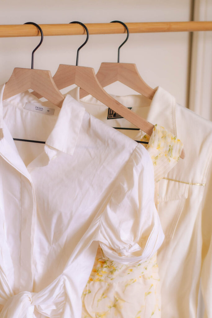 3 blouses featuring the most luxurious fabrics including a white Prada blouse, yellow floral Valentino blouse, and a white and gold Fendi jacket.