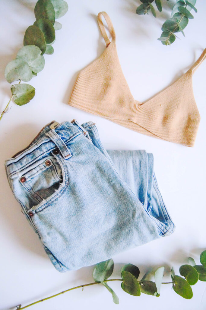 Tan knit bralette and a pair of blue jeans to represent sustainable Lenzing fabrics that are made from Eucalyptus wood pulp